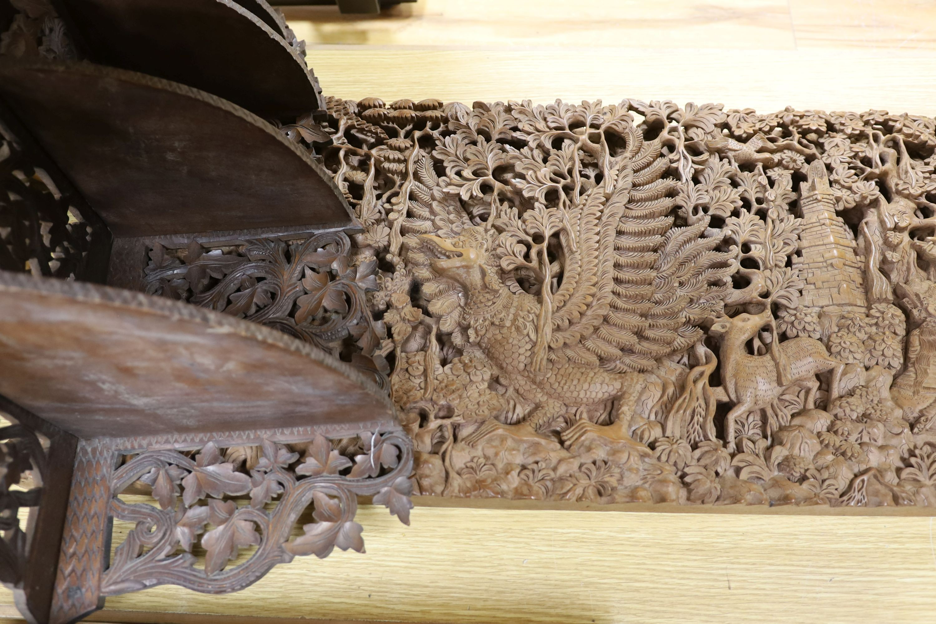 A Burmese or Indonesian graduated carved wall hanging what not, similar frame and carved panel
